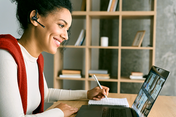 Female following an online training session on her laptop